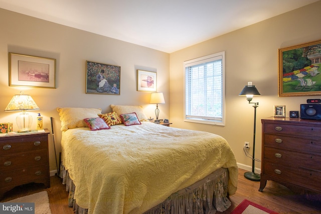 bedroom featuring baseboards and wood finished floors