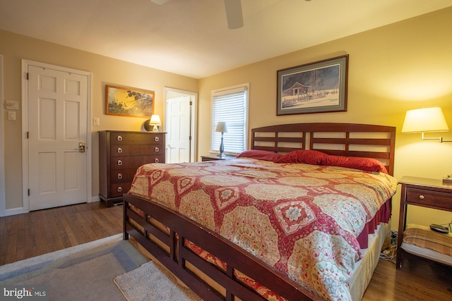 bedroom featuring a ceiling fan, baseboards, and wood finished floors