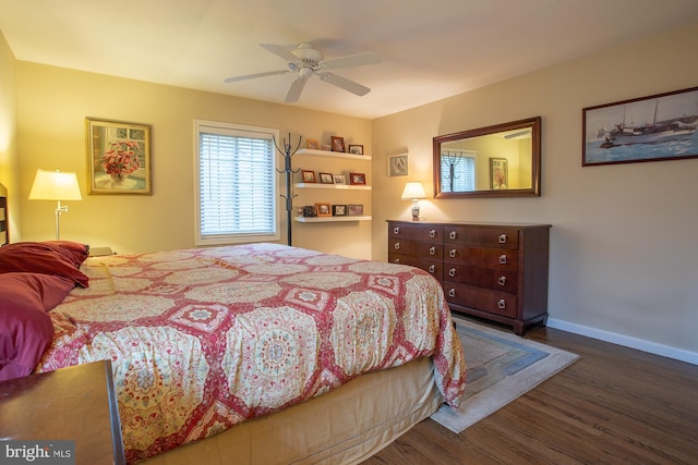 bedroom with baseboards, ceiling fan, and wood finished floors