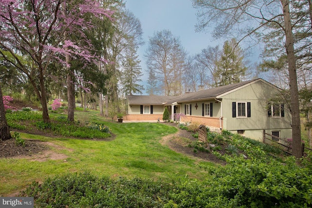 back of property featuring a chimney and a yard