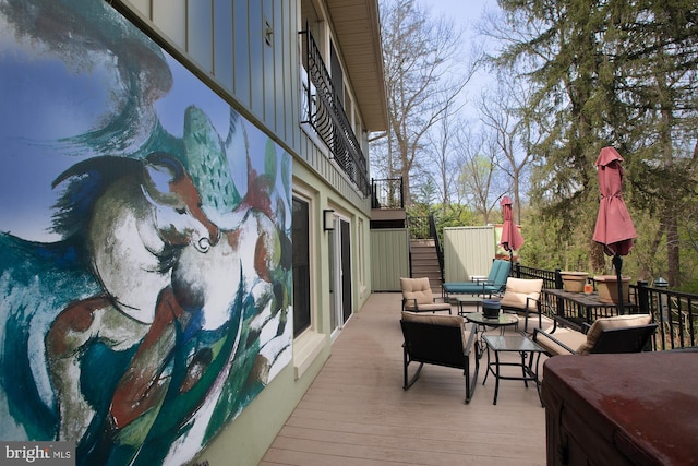 wooden terrace with an outdoor living space