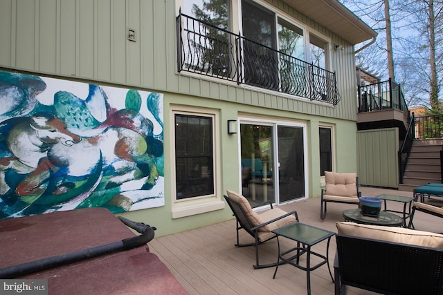 wooden deck featuring stairway and an outdoor hangout area