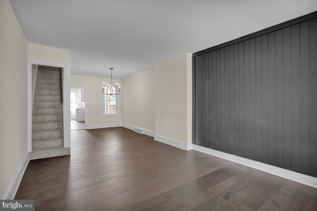 226 W Franklin St, Womelsdorf, PA 19567 - spare room featuring an inviting chandelier, visible vents, dark wood-style floors, and baseboards