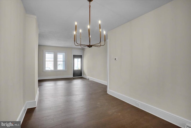 226 W Franklin St, Womelsdorf, PA 19567 - unfurnished dining area featuring baseboards, an inviting chandelier, and dark wood-style flooring