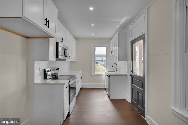 226 W Franklin St, Womelsdorf, PA 19567 - kitchen with decorative backsplash, appliances with stainless steel finishes, light countertops, a sink, and baseboards
