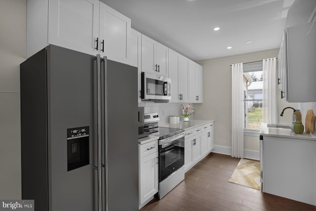226 W Franklin St, Womelsdorf, PA 19567 - kitchen with stainless steel appliances, light countertops, white cabinets, dark wood-style flooring, and baseboards