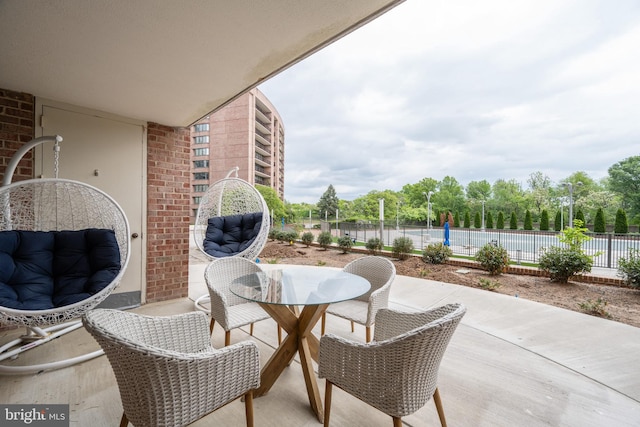 exterior space featuring outdoor dining area and fence
