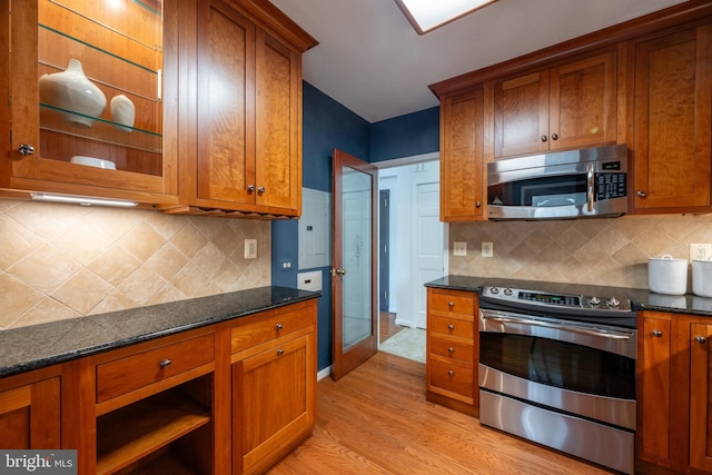 kitchen featuring brown cabinets, appliances with stainless steel finishes, and light wood-style floors