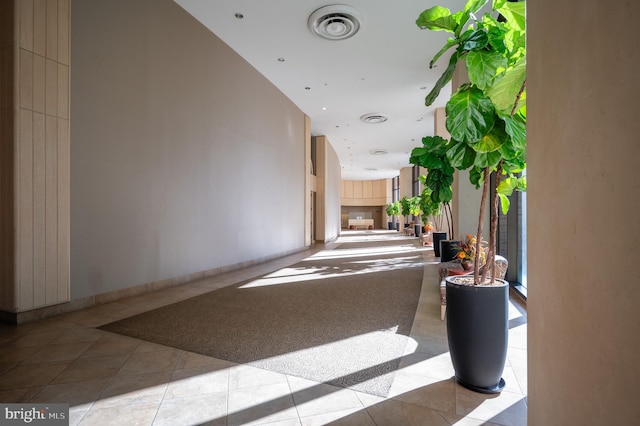 hall with visible vents and tile patterned flooring