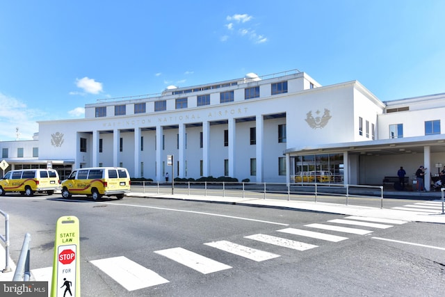 view of building exterior with uncovered parking