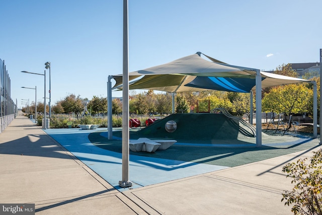 view of vehicle parking featuring playground community