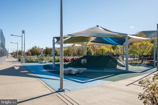 view of car parking featuring a playground