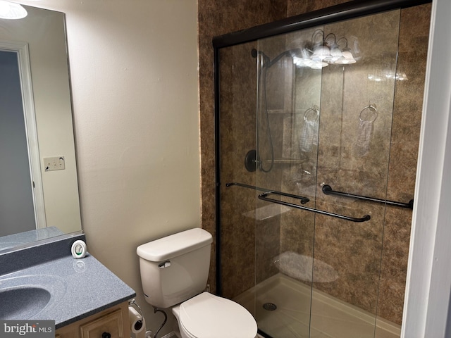 full bathroom with toilet, a tile shower, and vanity