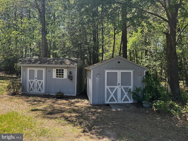 view of shed featuring a view of trees
