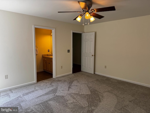 unfurnished bedroom featuring baseboards, ceiling fan, carpet, and connected bathroom