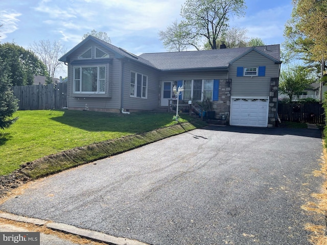 ranch-style house with driveway, a garage, and stone siding
