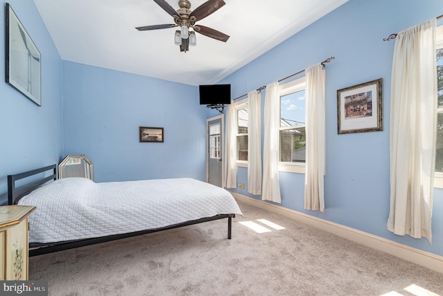 bedroom featuring a ceiling fan, baseboards, and carpet