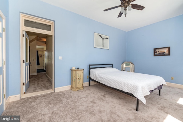 carpeted bedroom with baseboards and ceiling fan