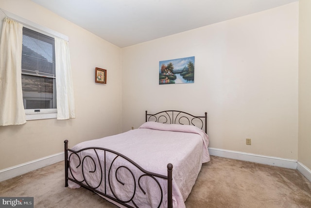 carpeted bedroom with baseboards