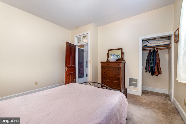bedroom with baseboards, visible vents, carpet, and a closet