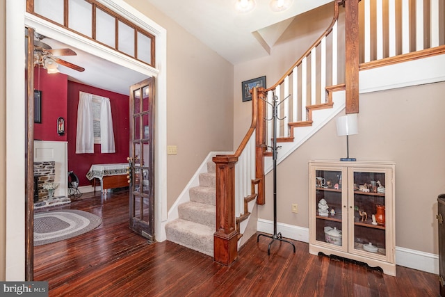 entryway with baseboards, a ceiling fan, stairs, and hardwood / wood-style floors