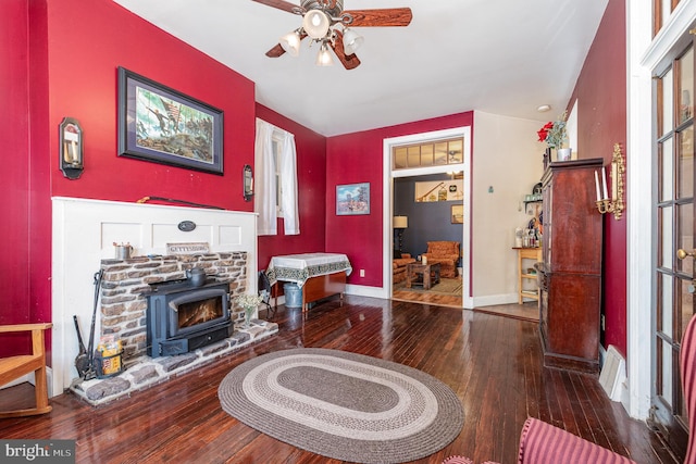 living room featuring visible vents, ceiling fan, and hardwood / wood-style flooring