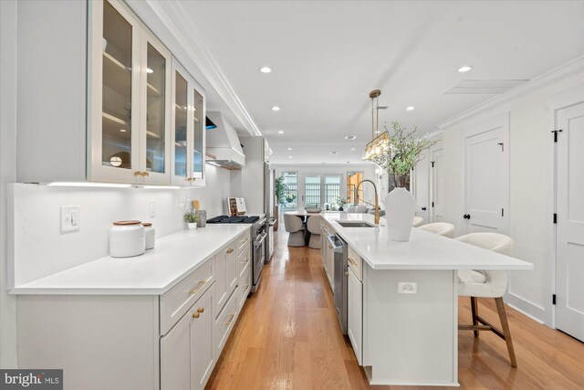 1708 10th St NW, Washington, DC 20001 - kitchen featuring a breakfast bar, a sink, premium range hood, stainless steel appliances, and recessed lighting
