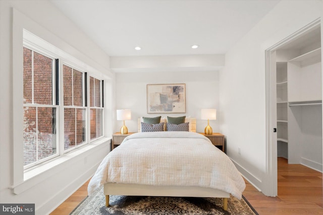 1708 10th St NW, Washington, DC 20001 - bedroom with baseboards, recessed lighting, a walk in closet, and light wood-style flooring