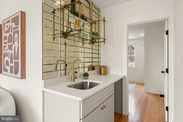 1708 10th St NW, Washington, DC 20001 - bar featuring a sink, baseboards, and light wood finished floors