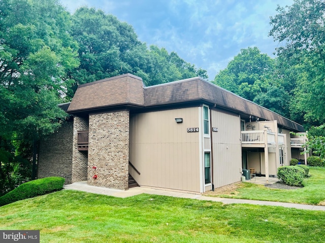5814 Royal Ridge Dr Unit Q, Springfield, VA 22152 - exterior space with a lawn, a balcony, brick siding, mansard roof, and roof with shingles