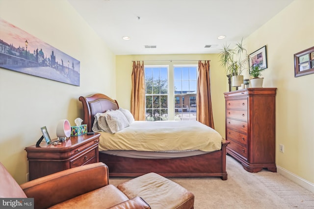bedroom featuring baseboards, light carpet, recessed lighting, and visible vents