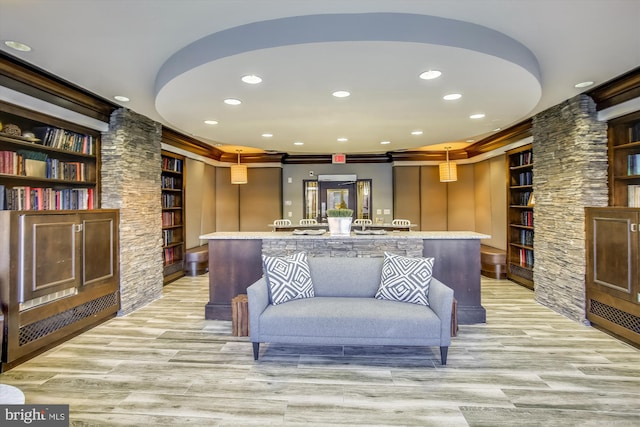 living room featuring built in features, recessed lighting, and light wood-style flooring