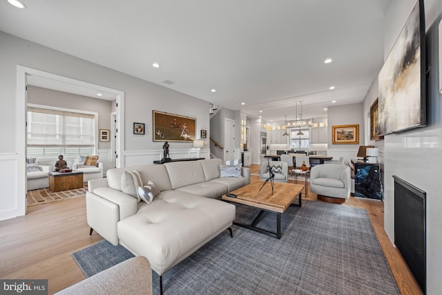 13 N Vendome Ave, Margate City, NJ 08402 - living room featuring wood finished floors, a wainscoted wall, a chandelier, recessed lighting, and a decorative wall