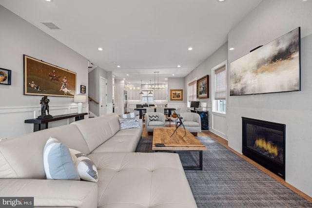 13 N Vendome Ave, Margate City, NJ 08402 - living room featuring wood finished floors, a glass covered fireplace, recessed lighting, and a chandelier
