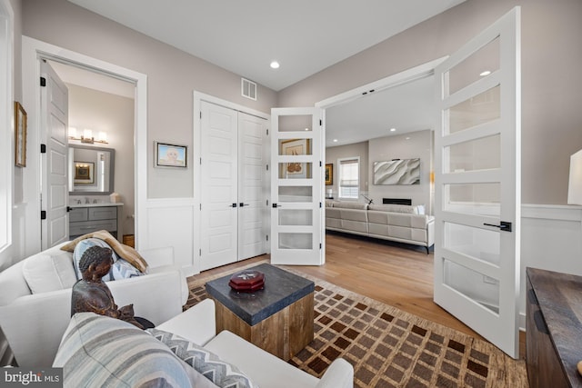 13 N Vendome Ave, Margate City, NJ 08402 - living room featuring dark wood-style flooring, french doors, recessed lighting, and wainscoting