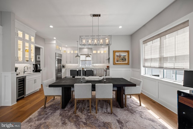 13 N Vendome Ave, Margate City, NJ 08402 - dining area with wine cooler, wood finished floors, healthy amount of natural light, a wainscoted wall, and recessed lighting
