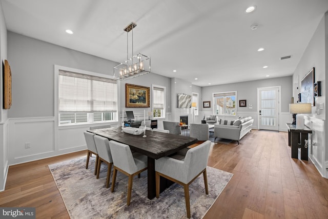 13 N Vendome Ave, Margate City, NJ 08402 - dining space featuring a chandelier, hardwood / wood-style floors, healthy amount of natural light, a lit fireplace, and recessed lighting