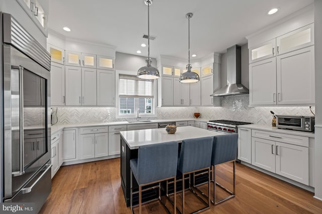 13 N Vendome Ave, Margate City, NJ 08402 - kitchen featuring appliances with stainless steel finishes, wall chimney range hood, a sink, tasteful backsplash, and recessed lighting