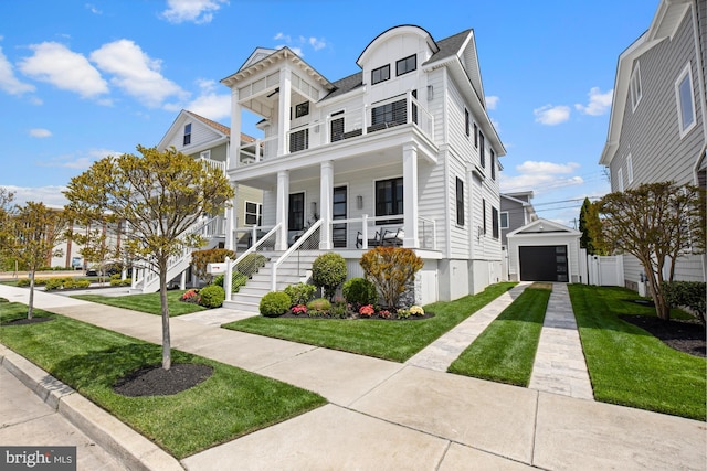 13 N Vendome Ave, Margate City, NJ 08402 - view of front of house with concrete driveway, a porch, a front lawn, a garage, and a balcony