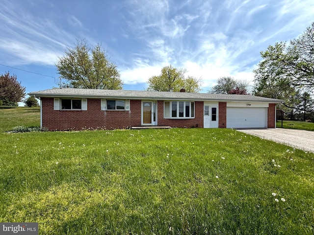 single story home with a garage, driveway, and brick siding
