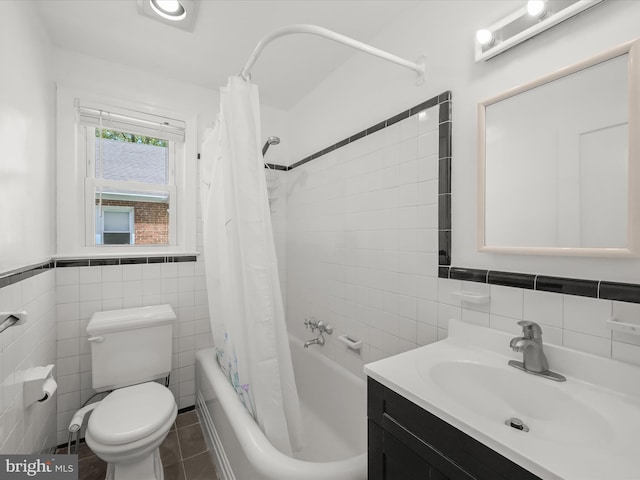 bathroom featuring shower / bath combo with shower curtain, vanity, toilet, and tile walls