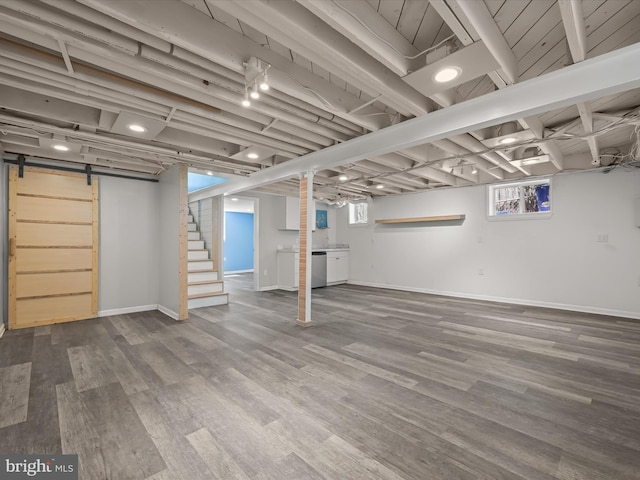 basement featuring stairway, baseboards, and wood finished floors