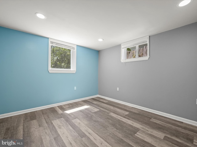 below grade area featuring baseboards, recessed lighting, and wood finished floors
