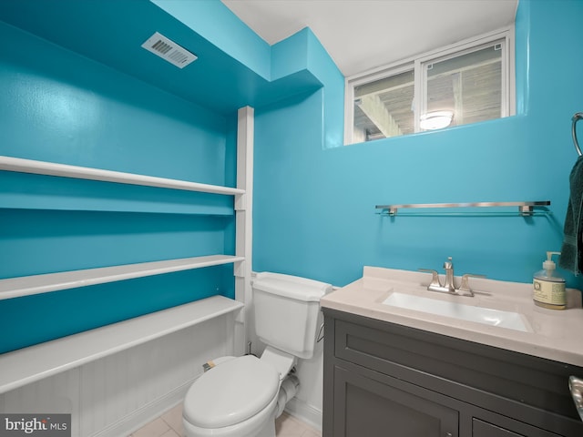 bathroom featuring toilet, visible vents, tile patterned flooring, and vanity