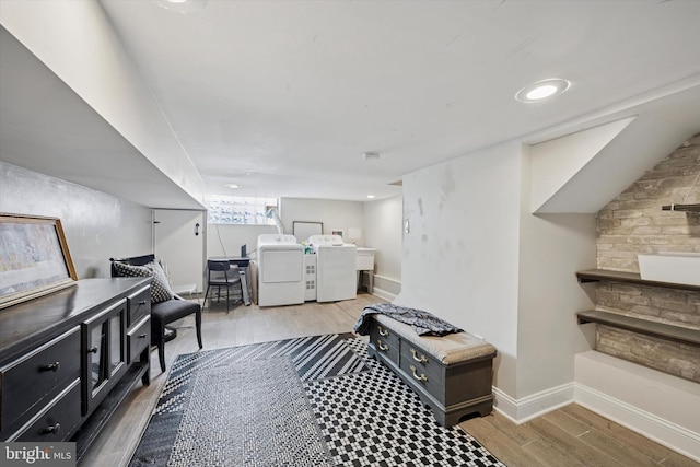 interior space with wood finished floors, independent washer and dryer, and baseboards