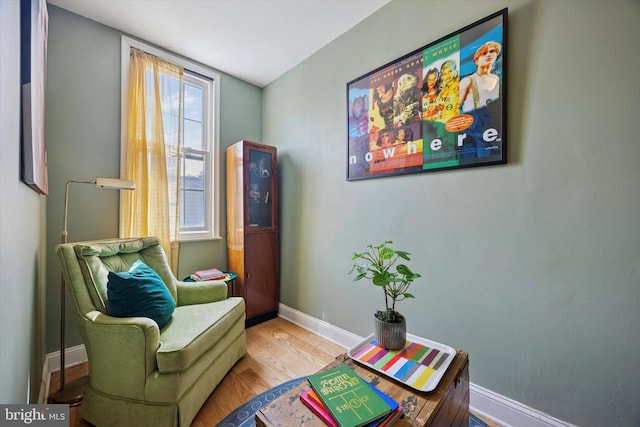 sitting room featuring baseboards and wood finished floors