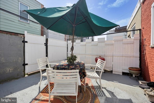 view of patio featuring fence and outdoor dining space