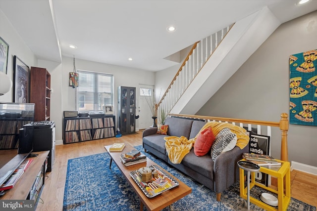 living area featuring wood finished floors, recessed lighting, stairs, and baseboards