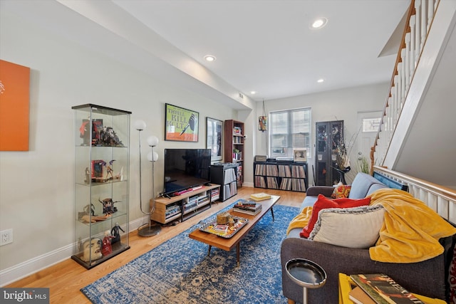 living area with recessed lighting, stairway, wood finished floors, and baseboards