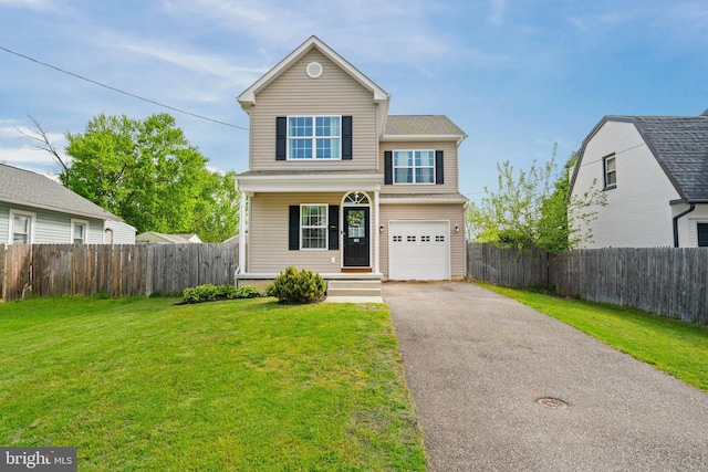 traditional home with covered porch, fence, driveway, and a front yard